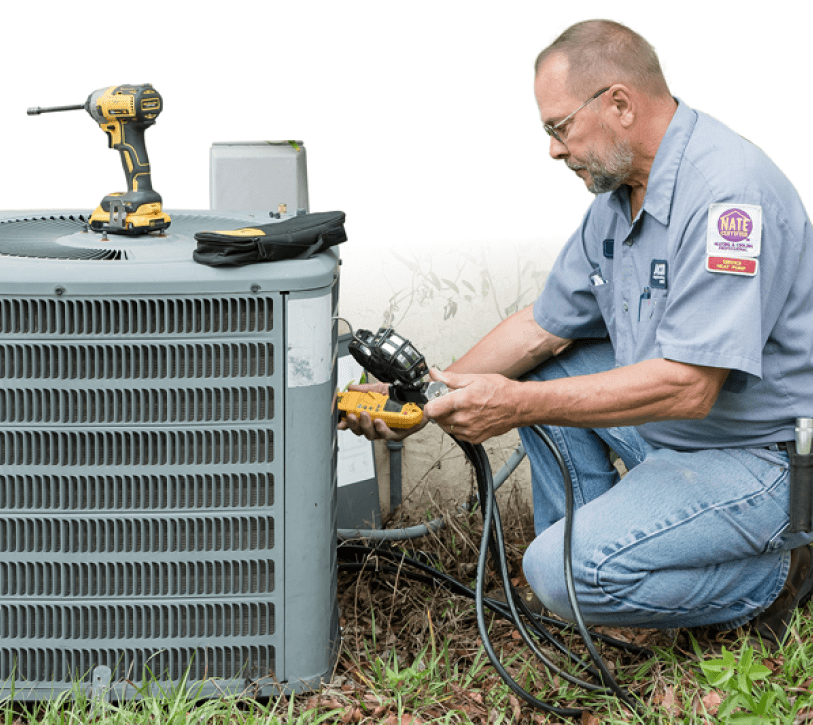 jacob Heating & Air Conditioning technician using tools to inspect an air conditioning unit