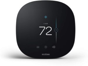 Black smart thermostat with the temperature reading seventy two degrees