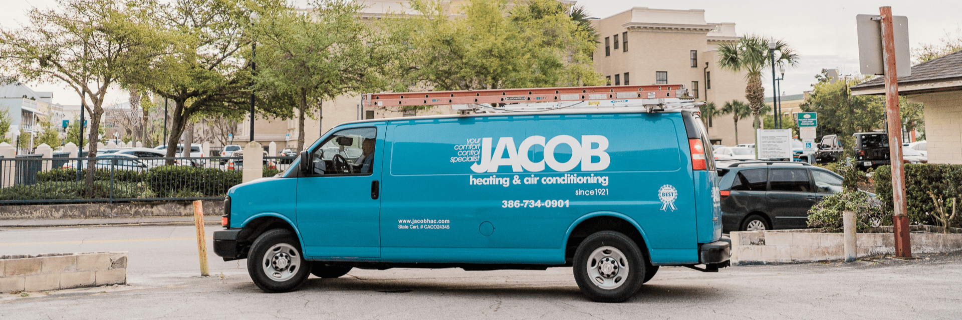 A teal blue Jacob Heating & Air Conditioning service van.