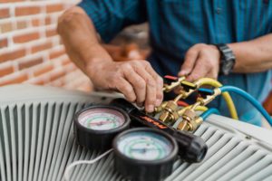 employees from Jacob Heating and Air working on an hvac system