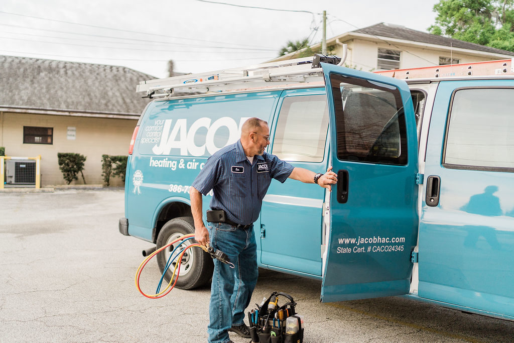 Jacob HAC employee closing the door on a blue company van