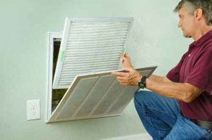 Man replacing home air filter