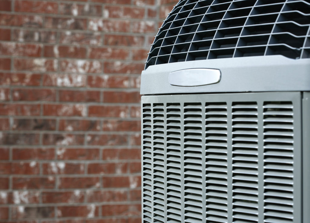 air conditioning unit outside a brick home