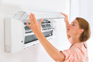 Woman inspecting air filter