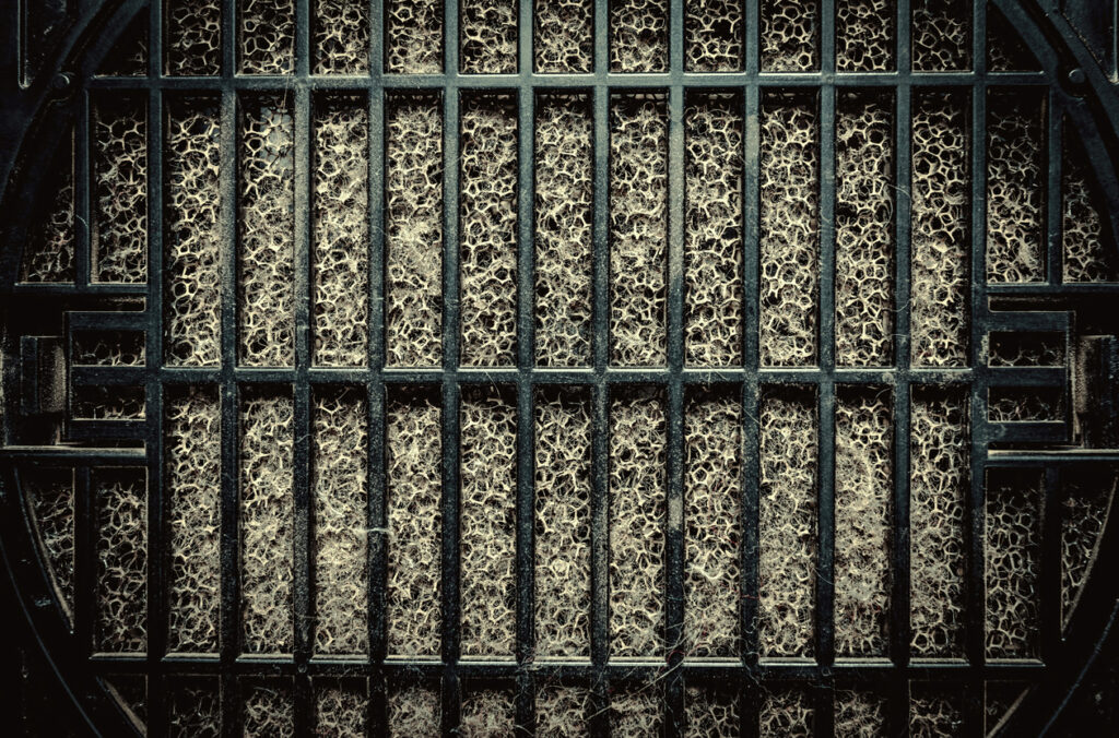 Detailed fragment of dirty air filter surface. Background texture.