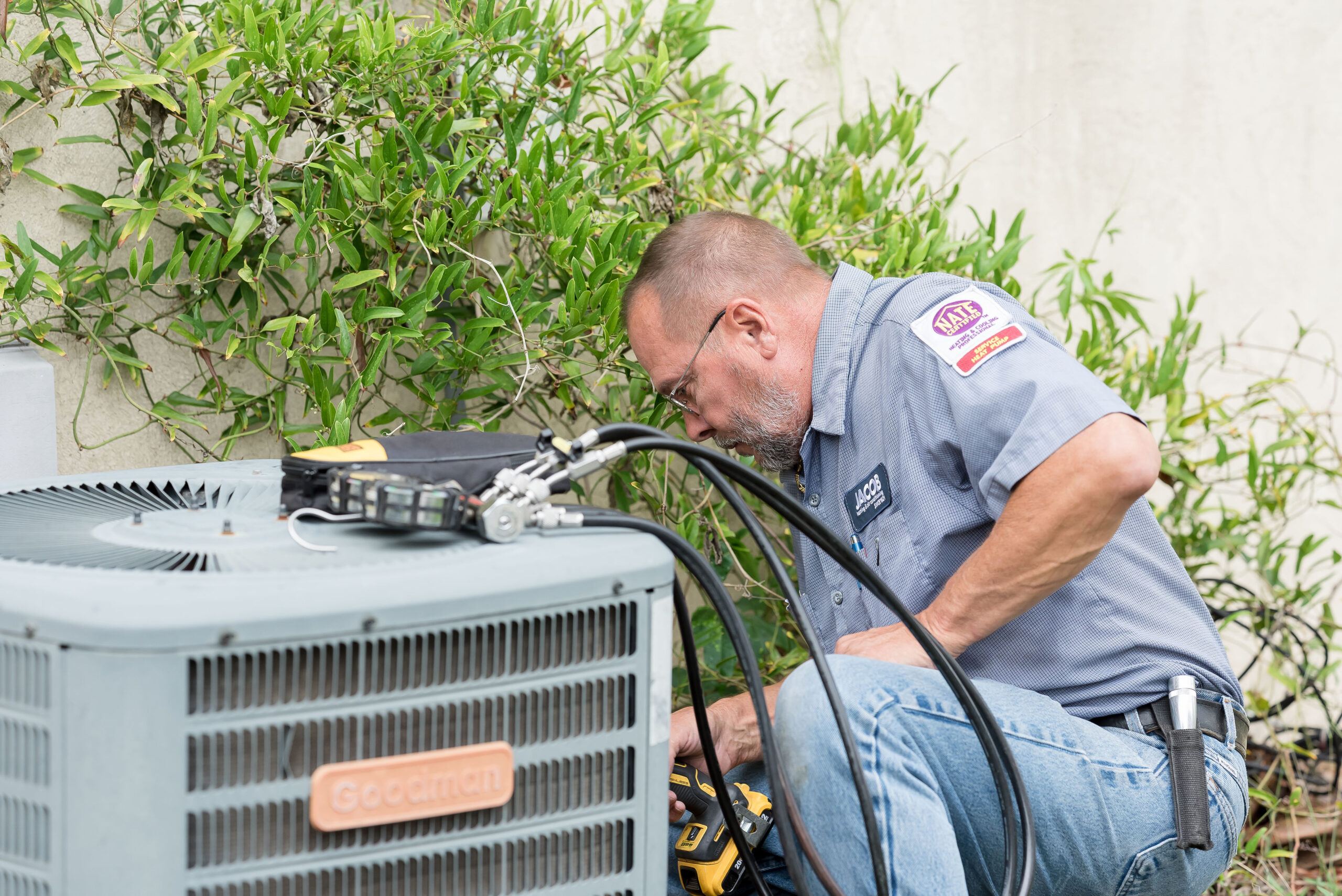 employee from Jacob Heating and Air working on an hvac system