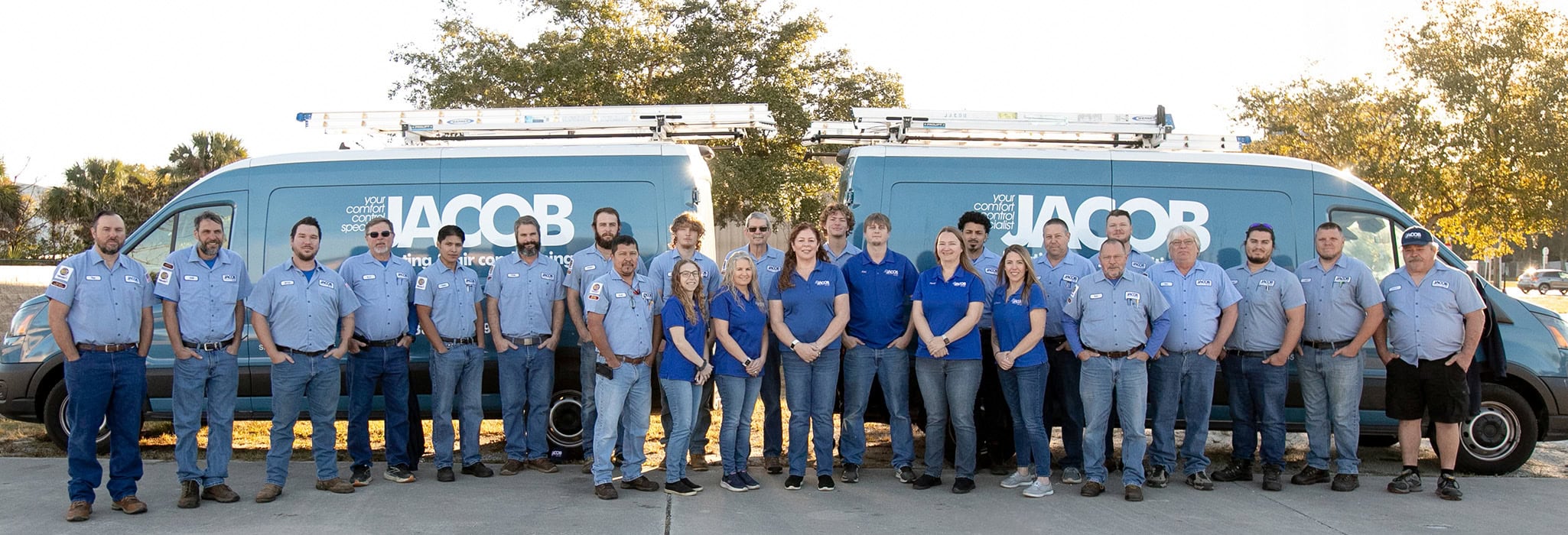 Jacob Heating & Air Conditioning team and HVAC service vehicles, outside DeLand, Florida office.
