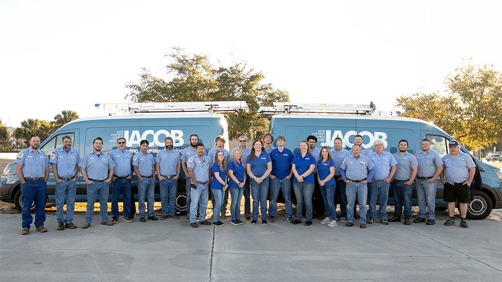 Jacob Heating & Air Conditioning team and HVAC service vehicles, outside DeLand, Florida office.